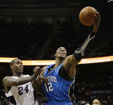 Orlando&nbsp;Magic's&nbsp;Dwight&nbsp;Howard&nbsp;(12)&nbsp;is&nbsp;fouled&nbsp;by&nbsp;Atlanta&nbsp;Hawks'&nbsp;Marvin&nbsp;Williams&nbsp;in&nbsp;the&nbsp;fourth&nbsp;quarter&nbsp;of&nbsp;an&nbsp;NBA&nbsp;basketball&nbsp;game&nbsp;Wednesday,&nbsp;March&nbsp;24,&nbsp;2010&nbsp;in&nbsp;Atlanta.(AP&nbsp;Photo/John&nbsp;Bazemore)